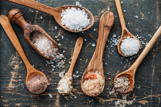 Wooden spoons with different sorts of salt