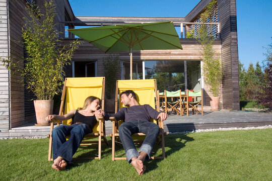 Couple sunbathing on loungers