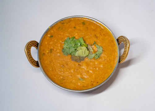 Dal Tadka Indian Food served in a traditional balti bowl garnished with fresh hara dhaniya