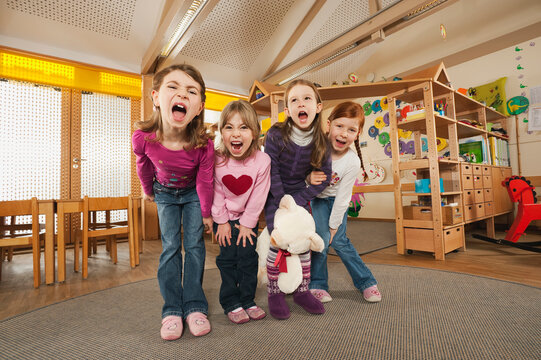 Germany, Children in nursery standing side by side screaming, portrait