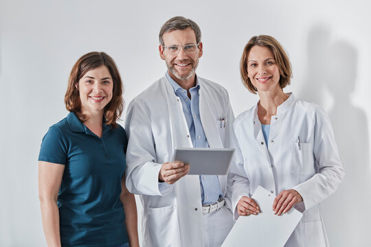 Doctors and medical secretary using tablet