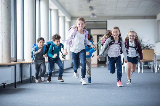 Eager students hurrying through the school hallway with enthusiasm and anticipation
