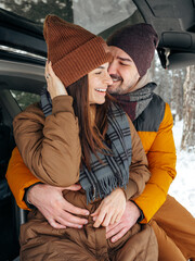 Fototapeta premium enjoys time together in snow covered forest during winter afternoon