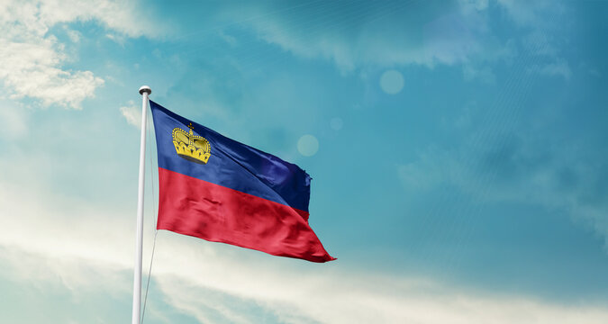 Liechtenstein national flag fluttering. The flag blowing in beautiful soft sky. Liechtenstein national flag for independence day.