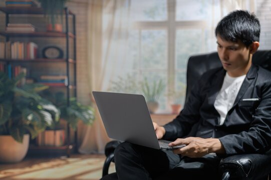 Young Professional Working on Laptop in Modern Workspace Setting
