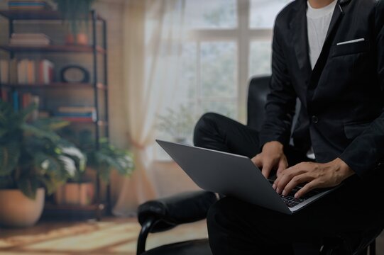 Young Professional Working on Laptop in Modern Home Office Setting