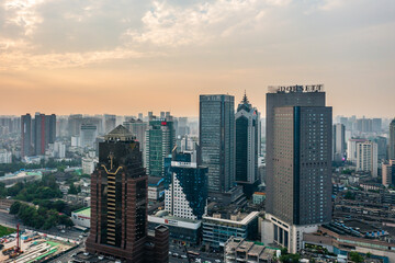 Obraz premium Aerial sunset city skyline of downtown Chengdu, dense modern high-rise office buildings and urban business district scenery at dusk, Sichuan China