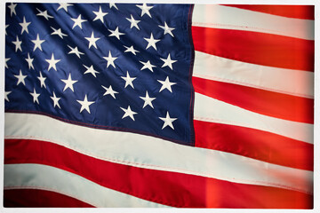 Fototapeta premium Close-up of the American flag in a white frame, featuring stars and stripes in vibrant red, white, and blue colors. Patriotic USA background with detailed fabric texture