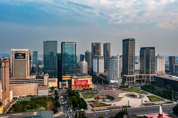 Obraz premium Aerial view of downtown Chengdu central square surrounded by modern high-rise skyscrapers and busy city road, Sichuan China urban business district scenery