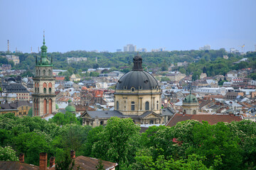 Fototapeta premium Panoramic aerial view of Lviv historic city center with ancient architecture and lush greenery