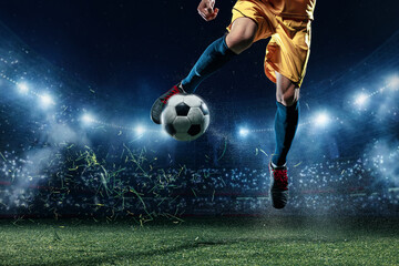 Naklejka premium Soccer player juggling ball in midair on illuminated stadium pitch. Concept of tournament promotion, club marketing, fan posters, sports media banners, and performance campaign visuals.
