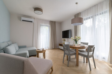 Fototapeta premium Modern bright living room with dining area and air conditioning