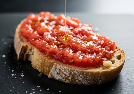 Delicious pan con tomate with olive oil drizzle on slate