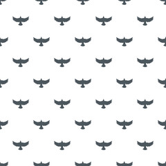 Obraz premium Bird silhouettes creating a seamless flying pattern on a clean white background
