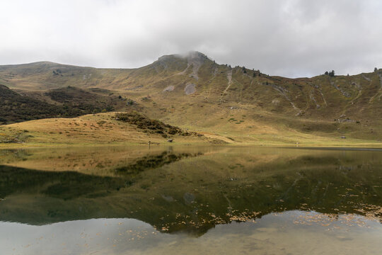 Mirror reflection on Lake Roy with cloudy sky in the Chablais massif, Haute-Savoie, French Alps