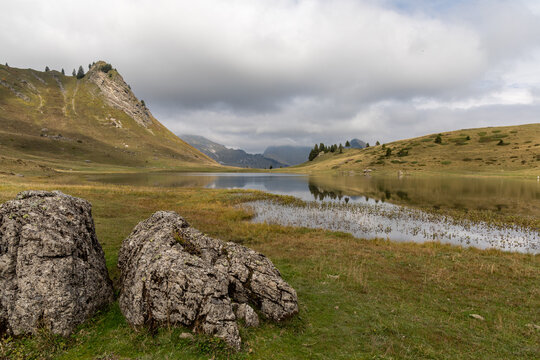 Mirror reflection on Lake Roy with cloudy sky in the Chablais massif, Haute-Savoie, French Alps