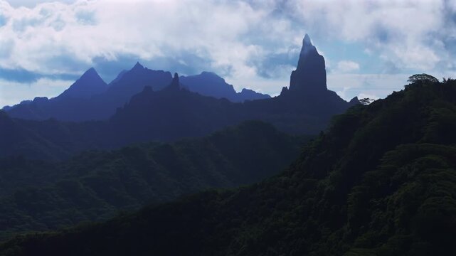 Moorea's dramatic volcanic tall jagged peaks rugged terrain Mount Rotui Mt Toheia French Polynesia aerial drone landscape Belvedere Lookout Cooks Opunohu Bay sunny afternoon blue sky clouds low fog