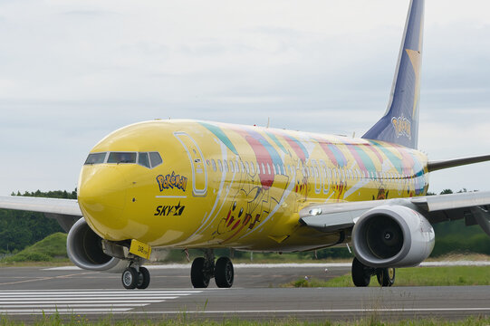 Ibaraki Airport, Japan - June 11, 2022: Skymark Airlines Boeing 737-800 (JA73AB) "Pikachu Jet BC1" Pokemon special livery taxiing on runway with pilot waving
