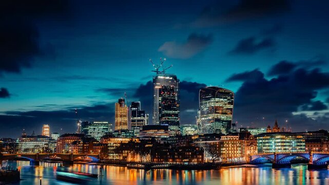 Stunning night view of modern London city skyline with illuminated skyscrapers and river reflections