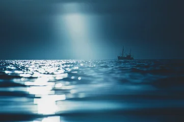 A solitary fishing boat sails on a dark, moonlit ocean with a column of soft light breaking through low cloud and reflecting across rippling water. The scene © Florian Kunde