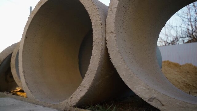 Concrete well rings lying on ground close-up for septic tank or well construction