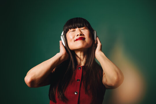 Streaming audio sets the mood as the woman listens with headphones