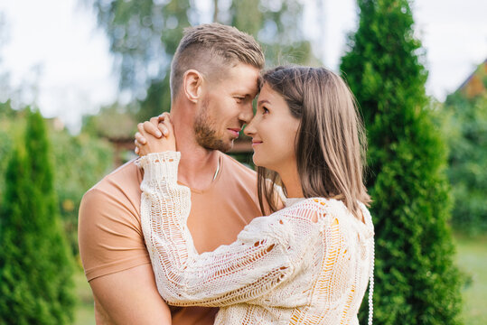 Romantic Couple Closeup Portrait In Garden With Tender Embrace