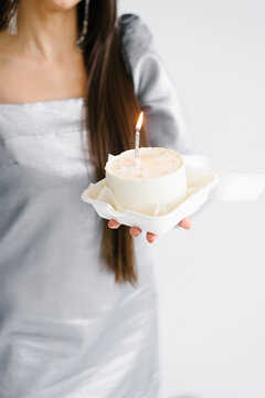 Bento Cake with Lit Candle in Female Hands