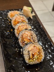 Gourmet sushi maki rolls on elegant black plate © Sugar Love Love