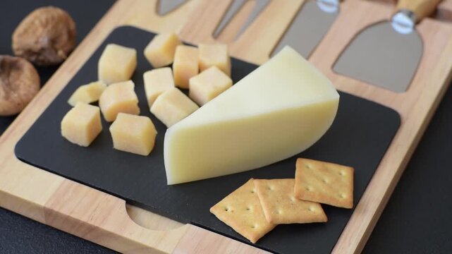 Aged cheese in a triangular block with jam, figs, and nuts. Aged cheese as a food background for your design