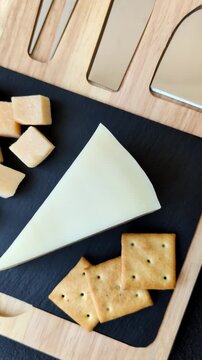 Aged cheese in a triangular block with jam, figs, and nuts. Aged cheese as a food background for your design