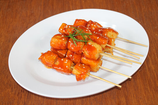 Spicy grilled tofu satay skewers with sesame seeds garnish