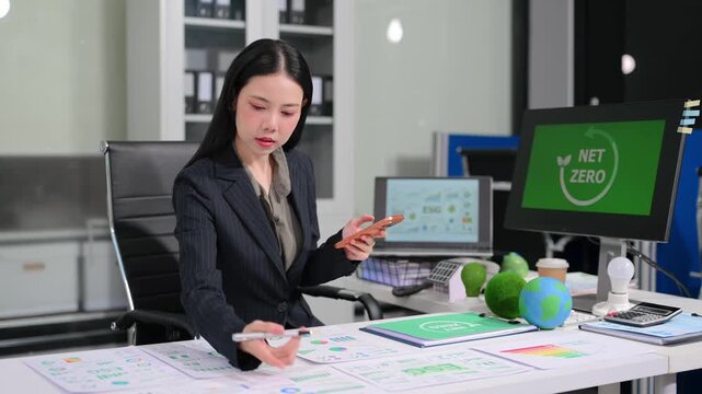 businesswoman reviewing ESG data and Net Zero reports in a modern office, highlighting sustainability, green business, renewable energy and corporate responsibility.