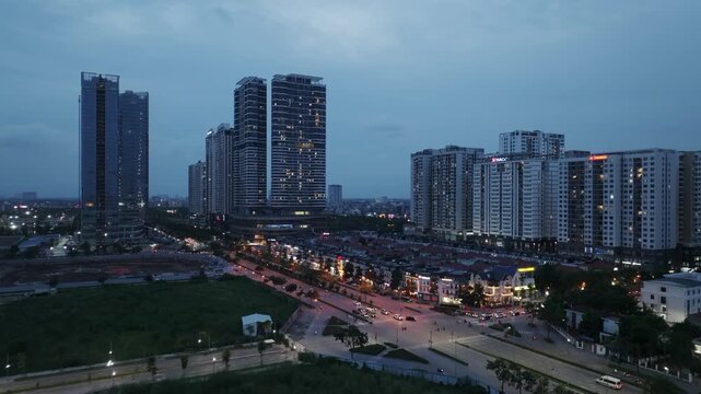 Blue hour view of the Diplomatic Corps area along Hoang Minh Thao Street in Hanoi with modern residential towers and illuminated streets.