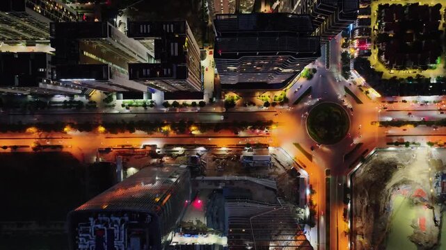 Top-down night view of a roundabout along Hoang Minh Thao Street in Hanoi with illuminated roads and surrounding residential towers.