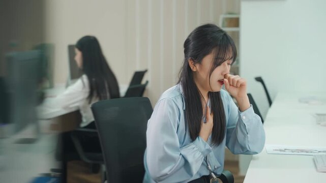 Stressed overwhelmed businesswoman sick and coughing in office, experiencing workplace illness virus spread for infection, sinus and cold symptoms, indicating fatigue and potential viral infection