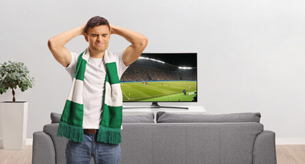 Disappointed man standing in front of a tv © Ljupco Smokovski