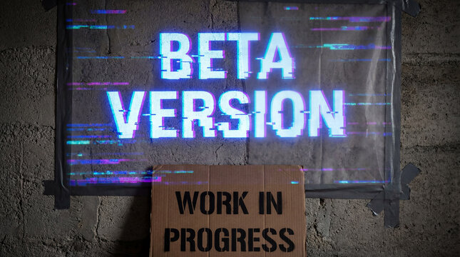 Beta version and work in progress text with glitch effect on a poster and cardboard sign on a concrete wall