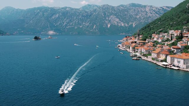 Seaside vessel approaching quaint village. Marine vessel nearing charming coastal town with scenic backdrop