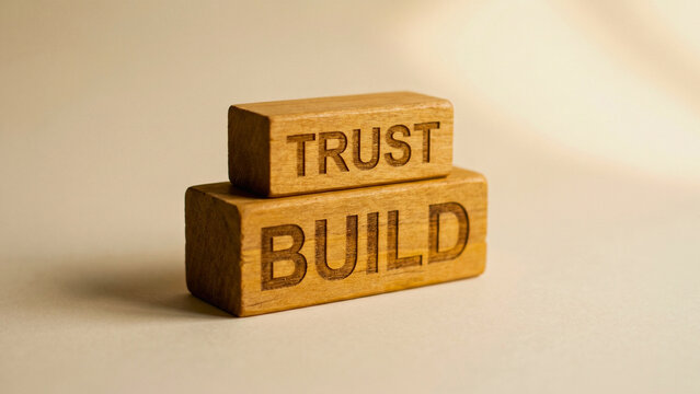 Stacked wooden blocks spelling Build Trust on cream surface vertical, corporate trust building concept, customer loyalty strategy, relationship management, brand integrity 