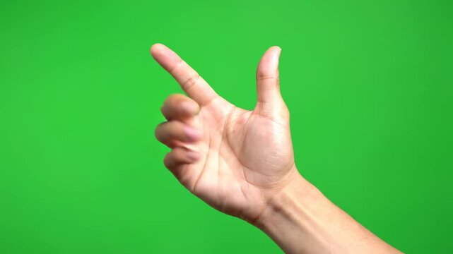 Hand holding white smartphone isolated on green background close up