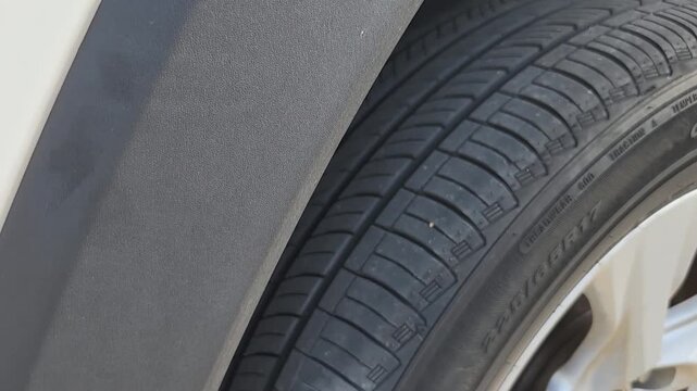 Video footage showing a vehicle tire rotating slowly during a maintenance inspection. Automotive footage highlighting tread condition, wheel movement, tire wear analysis, and preventive vehicle servic