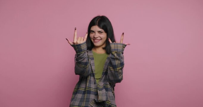Fun moments with a girl showing different hand signs in a studio at day time