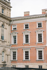 Obraz premium Traditional stone structure with decorative features. Serene street view showcasing timeless masonry and architectural details in soft daylight
