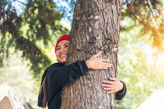 Woman Hands hug tree love nature finger heart shape. Save world zero waste energy protect Eco green sustainable hands holding together.  ESG environment sustainable governance ecology on earth day