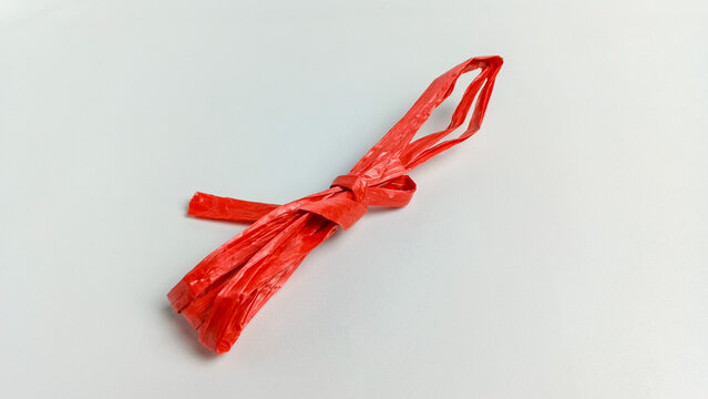 Red raffia rope over white background. raffia rope is used for tying.