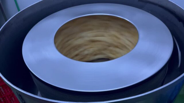 Fish maw undergoing dewatering and oil removal during food manufacturing operations. Ingredient preparation process used to improve product consistency and support large-scale food production.