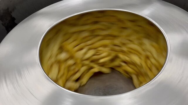Fish maw undergoing dewatering and oil removal during food manufacturing operations. Ingredient preparation process used to improve product consistency and support large-scale food production.