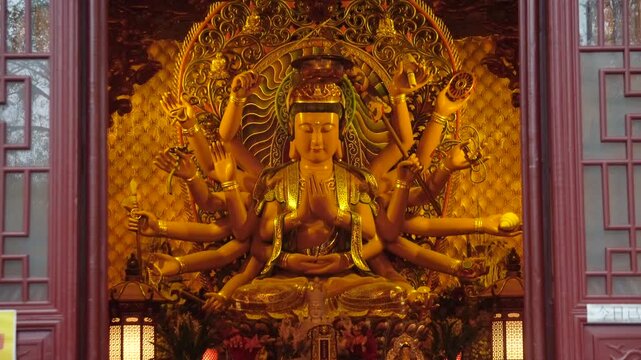Golden Multi Armed Buddhist Statue Inside Temple Shrine