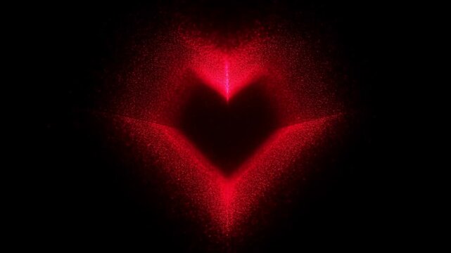 Slow motion particle reveal of red heart shape forming and expanding on black background in symmetrical plume